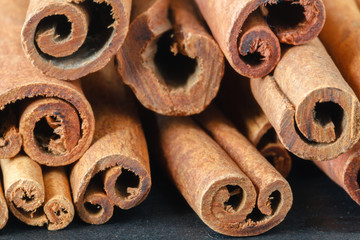 Close up bunch cinnamon sticks on dark wooden table