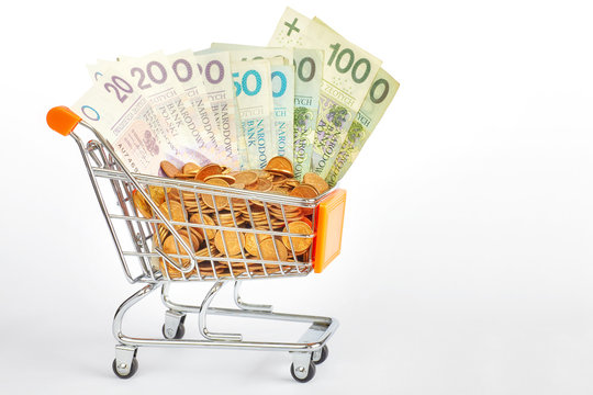 Shopping cart filled with polish zloty bills and grosz coins.