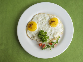frying eggs with tomatoes