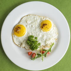 frying eggs with tomatoes