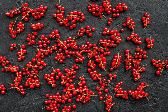 Berry pattern. Red currant on black table background top view