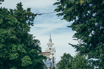 Obraz premium Tower of South-East Railway Administration Building in frame of green trees in Voronezh