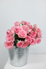Pink bush roses in a bucket