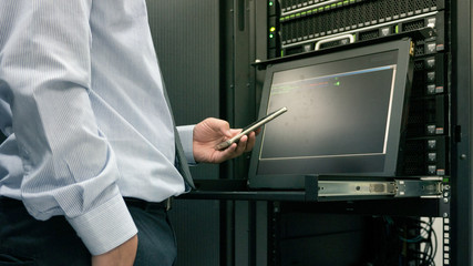 close up man use smart phone in data center