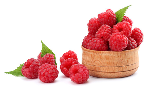 ripe raspberries in wooden bowl isolated on white background close up