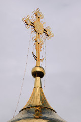 Fototapeta na wymiar Orthodox cross on a gold dome.