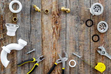 Plumber tools on wooden background top view copyspace