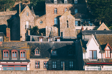 Buildings in Le Mont Saint-Michel tidal island in beautiful twilight at dusk, Normandy, France