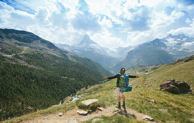 Fototapeta na wymiar Man hiking to Matterhorn Mountain in summer in Zermatt city, Switzerland