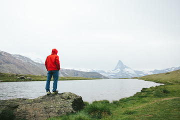 Fototapeta premium Hiker looking at Matterhorn mountain in the distance