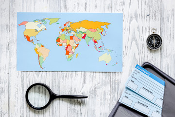 Search and buy tickets for travel. Tickets and world map on light wooden table background top view