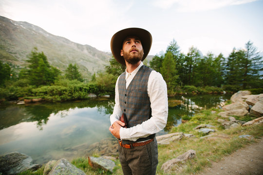 Young Pastor Preacher Holding Holy Bible And Looking To The Mountains