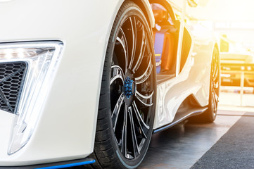 Font of a white sport car in sunset