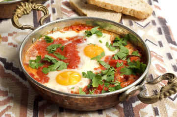 Tomato and red pepper shakshouka with hummus and wholemeal bread