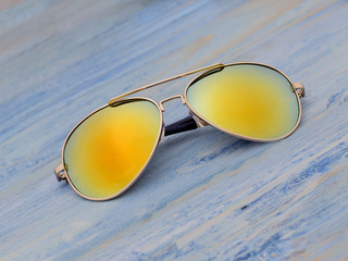 Sunglasses on a wooden board. 