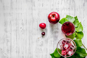 Summer fruit drink with apple, cherry and pulm on wooden table top view copyspace