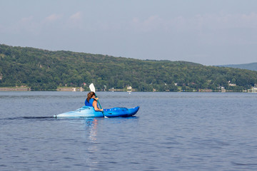 Fototapeta na wymiar woman kayaking on a calm lake