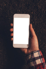 Female farmer holding smartphone with blank mock up screen