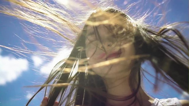 Hair of pretty little girl hair is blowing in the wind