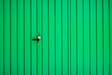 Green garage gate with padlock