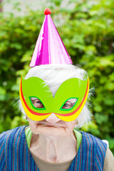 Masked elderly woman celebrating birthday