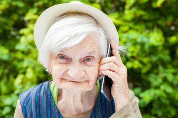 Happy smiling grandmother talking on mobile phone