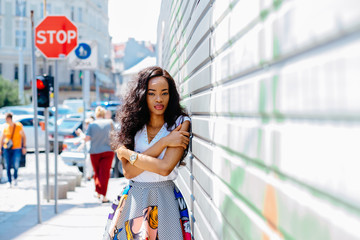 Young stylish african woman over iron gray fence.