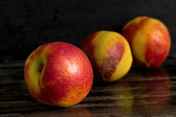 Fototapeta na wymiar bright fresh juicy peaches on a dark background