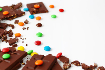sweet chocolate bar and color candy in white background