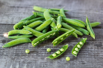 young juicy green peas on a wooden table