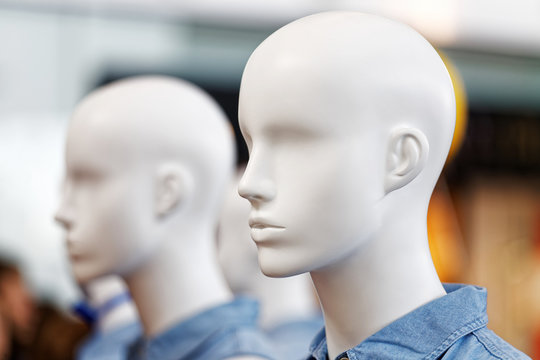 Closeup plastic mannequin heads against blurred background. Shallow focus.