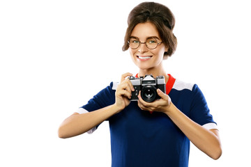 Woman model in vintage look holding retro camera in her hands