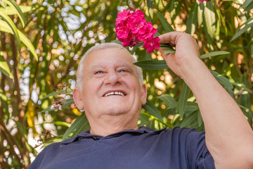 close-up of soft skinned old man with oleander
