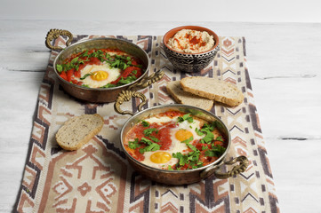 Tomato and red pepper shakshouka with hummus and wholemeal bread