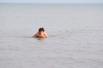 Thirteen year old boy in the water of Lake Erie