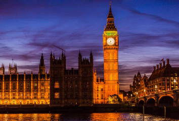 Fototapeta na wymiar Big Ben and Houses of parliament at twilight on Westminster bridge in London, UK. Lit building at night, nightlife photography.