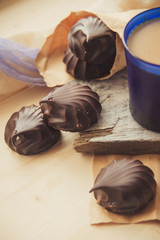 A cup of cafe latte with coffee beans and cookies