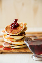 Stack of pancakes with jam and sugar