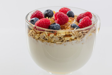 cup of milk with cereals and berry