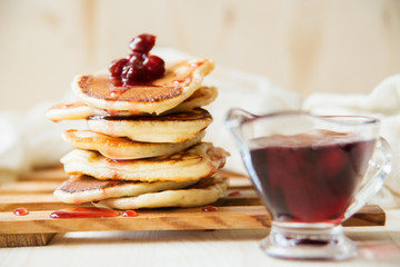 Stack of pancakes with jam and sugar
