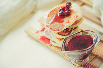 Stack of pancakes with jam and sugar