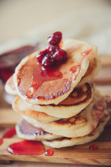 Blueberry pancakes on a contrasting black background. Close up