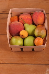 Pears, peaches and apricots in the basket