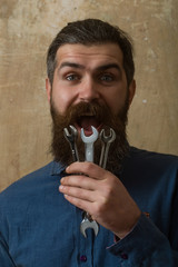 happy man hipster with beard hold wrench in hand