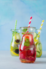 Refreshing summer homemade cocktail in glass bottles. Detox fresh water. Selective focus. Copy space.
