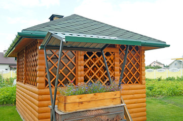 Arbor and barbecue grill in the yard.