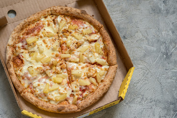 Hawaiian pizza in box on table, closeup
