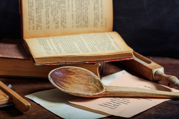 Wooden spoon and a vintage book