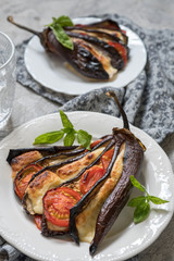 Baked eggplant with cheese, tomatoes and basil