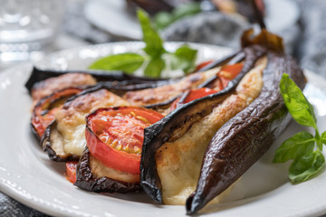 Baked eggplant with cheese, tomatoes and basil
